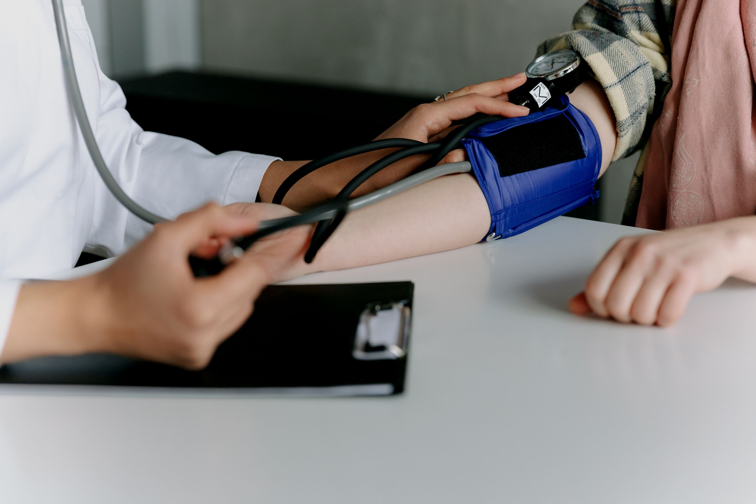 A Healthcare Worker Measuring a Patient's Blood Pressure Using a Sphygmomanometer